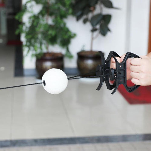 The ball riding along the cord towards the hand grip, held in one hand